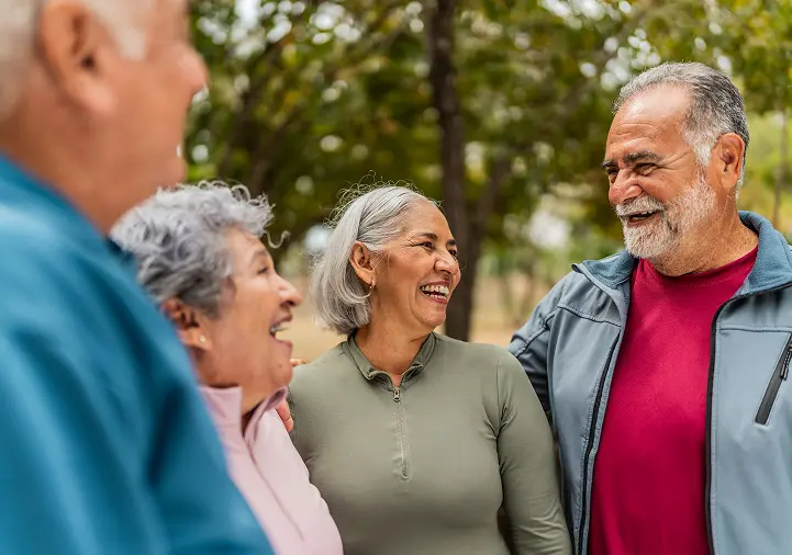 happy seniors outdoors talking with each other